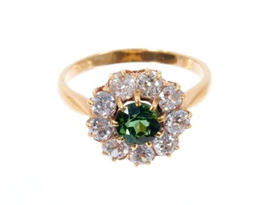 Lot 551 - Green tourmaline and diamond cluster ring with a central round mixed cut green tourmaline surrounded by a border of nine old cut diamonds in claw setting on 18ct yellow gold shank, estimated total...