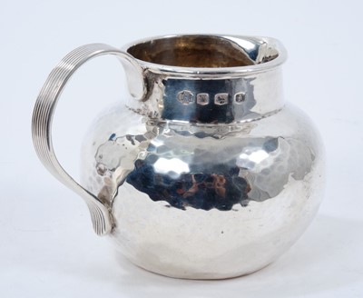 Lot 228 - 1920s silver cream jug of baluster form, with spot hammered finish