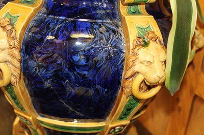 Lot 187 - Large 19th century English majolica jardinière, decorated in relief with lion masks and paw feet on six columns, on a marbled blue ground, 44.5cm height, containing a plant