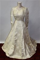 Lot 1455 - Circa 1950s wedding dress in cream satin silk...