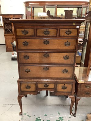 Lot 850 - George III style oak and elm chest on stand with dentil cornice, three short over three long graduated drawers and three small drawers below with mahogany crossbanding and brass handles, shaped apr...