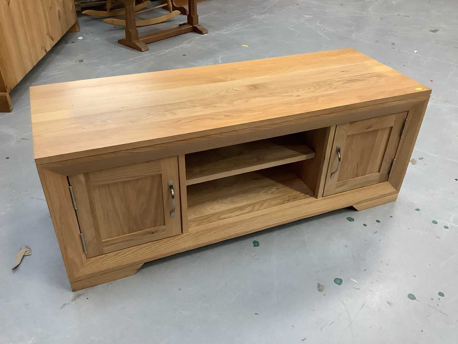 Lot 878 - Contemporary light oak television unit, together with a modern beech rocking chair (2)