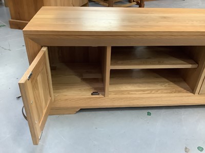 Lot 878 - Contemporary light oak television unit, together with a modern beech rocking chair (2)