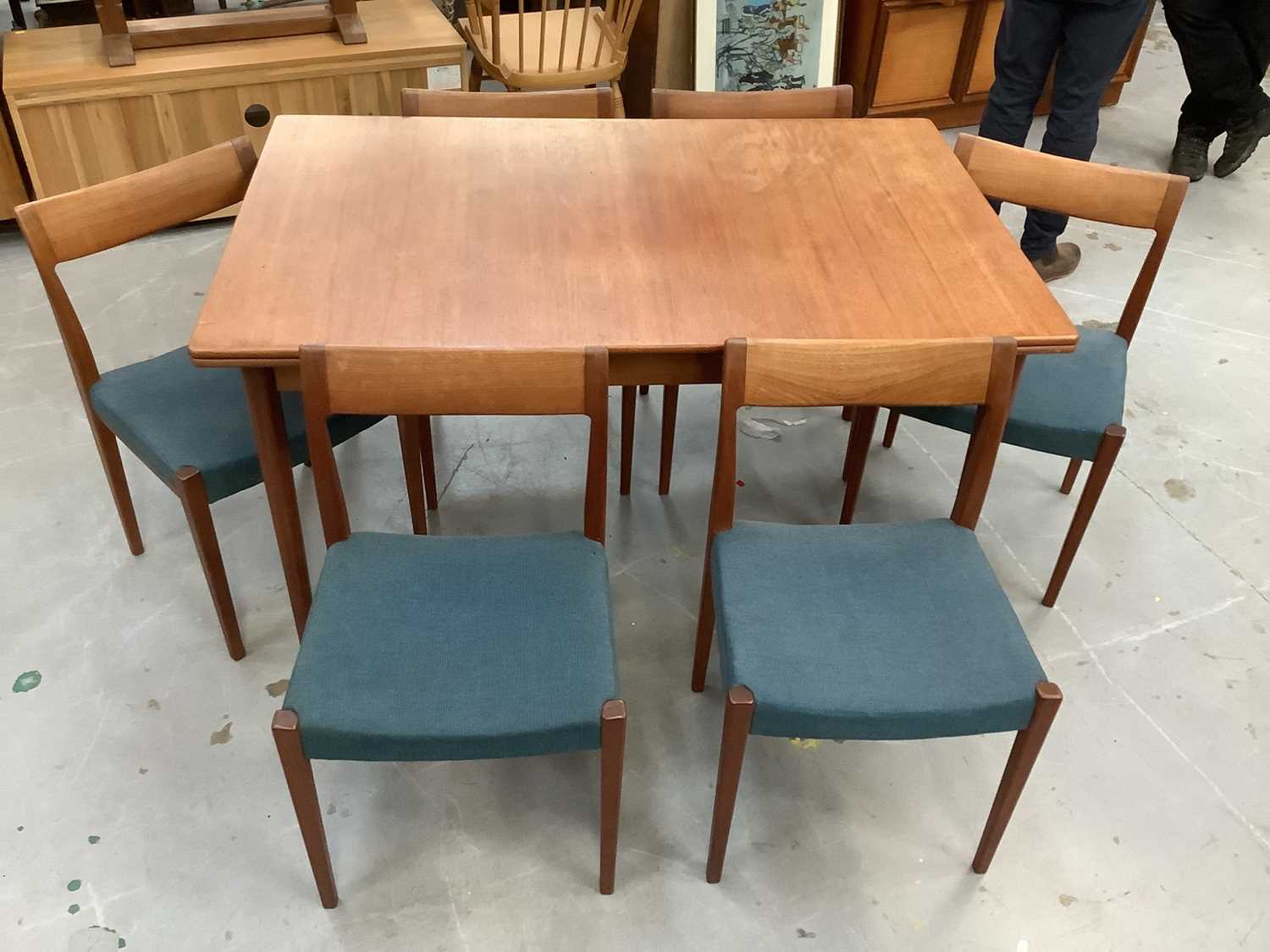 Lot 881 - A set of six 1960s Swedish teak Kontiki dining chairs and extending dining table, by Yngve Ekstrom for Troeds, the chairs with blue stuffover seats, on gently tapering supports, stamped marks verso
