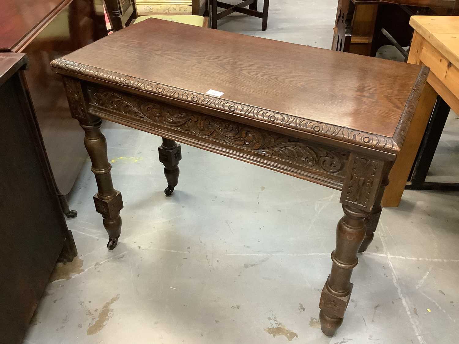 Lot 887 - Edwardian oak rectangular card table with fold-over top, on carved legs