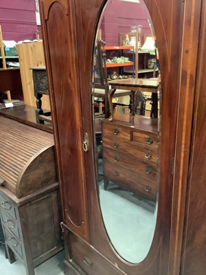Lot 893 - Edwardian inlaid mahogany wardrobe with central oval mirrored door above a single drawer