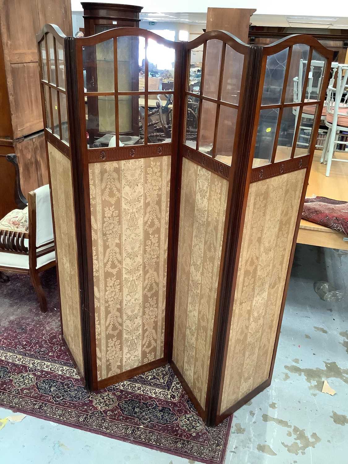 Lot 907 - Edwardian four-fold dressing screen and an Edwardian carved walnut cupboard enclosed by two carved panelled doors