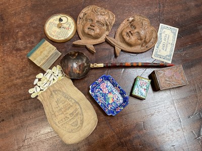 Lot 11 - Group of mixed items to include enamel dish and matchbox cover, pair of carved cherub mounts, miniature cowrie shells, 18th century tortoiseshell, coral and white metal mounted spoon and other items