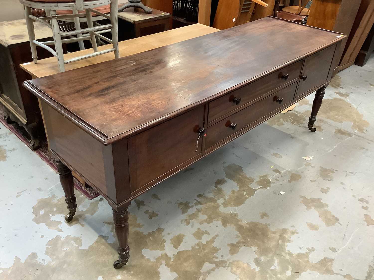 Lot 919 - George IV mahogany sideboard with two drawers flanked by twin cupboards, on turned legs and brass castors 
Provenance: Removed from Argyll House, Kings Road, London