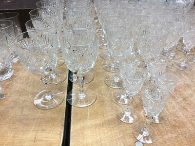 Lot 272 - Comprehensive suite of Webb Crystal cut glass table wares comprising claret jug, x2 decanters, fruit bowl, x11 water glasses, x12 red wine glasses, x12 white wine glasses, x11 finger bowls, x12 Des...