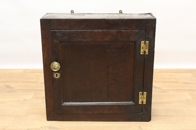 Lot 1427 - 18th century oak hanging cupboard with three spice drawers and shelf enclosed by a panelled door with brass H hinges