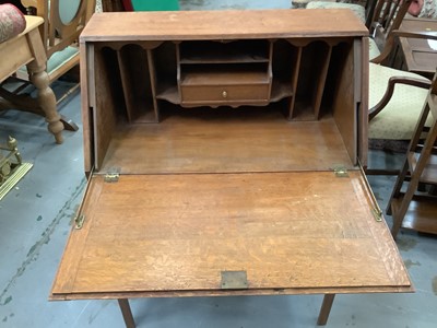 Lot 917 - Edwardian oak bureau with drawer on stand 73 cm wide and oak narrow bookcase 56 cm wide (2)