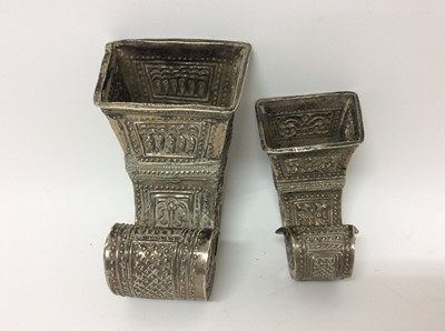 Lot 661 - Pair of Eastern white metal vessels of scroll form with embossed foliate decoration