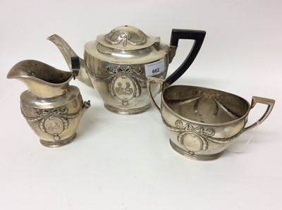 Lot 662 - German silver (800) three piece teaset with bow and swag decoration and engraved double crest, retailed by W. Kluge & Co, Berlin