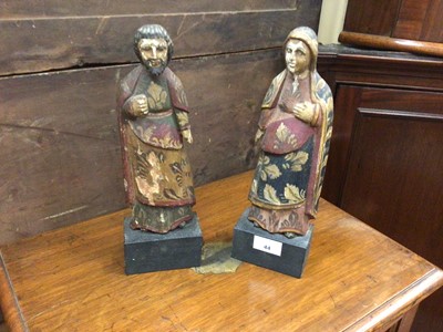 Lot 44 - Pair of antique Continental painted wooden figures raised on ebonised bases