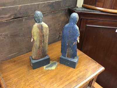 Lot 44 - Pair of antique Continental painted wooden figures raised on ebonised bases