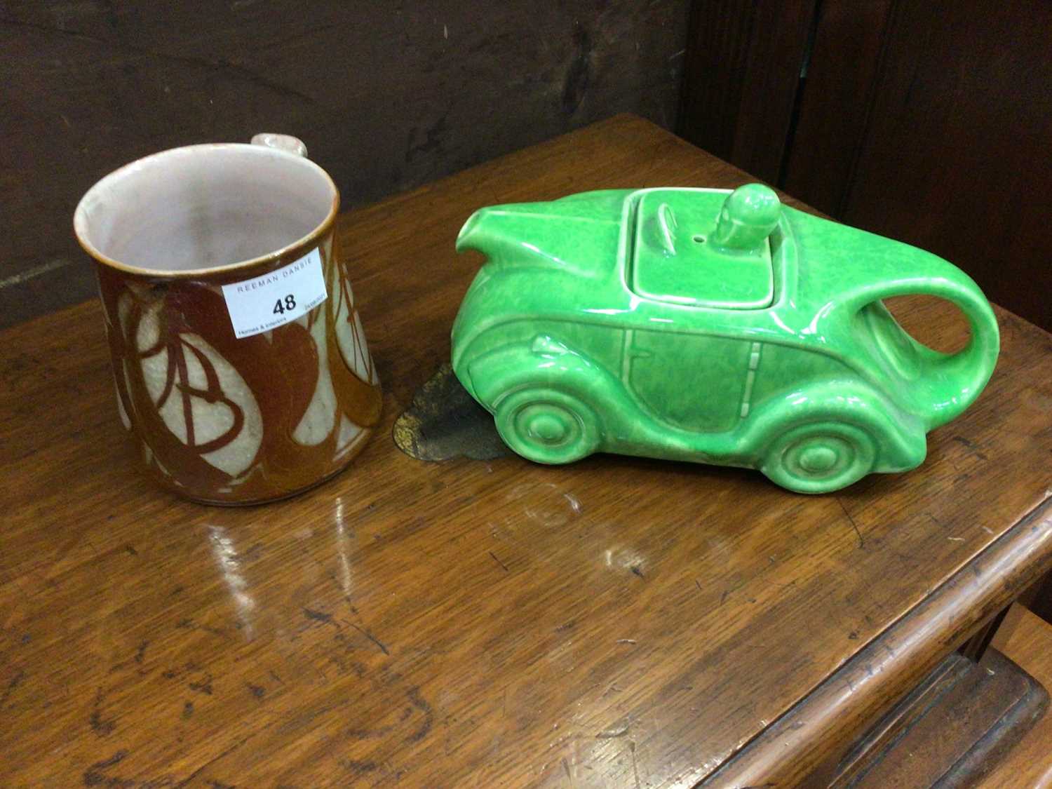 Lot 48 - Alan Caiger-Smith glazed mug together with a Sadler green glazed car shaped teapot