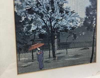 Lot 18 - Japanese woodblock print in frame, depicting a female figure holding a parasol with a pagoda in the background, possibly after Shiro Kasamatsu