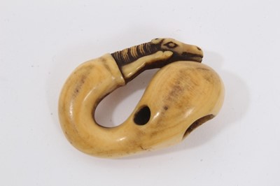 Lot 704 - Japanese Edo period carved ivory netsuke in the form of a  horse and gourd, with yellow patina