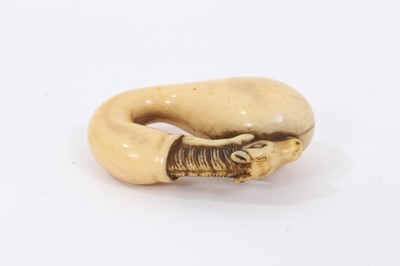 Lot 704 - Japanese Edo period carved ivory netsuke in the form of a  horse and gourd, with yellow patina