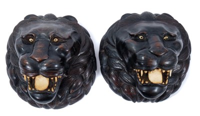 Lot 702 - Pair of Indian carved wooden lion's heads with bone eyes, teeth and tongue