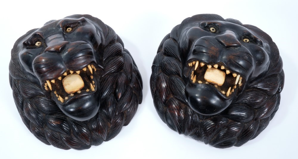 Lot 702 Pair of Indian carved wooden lion's heads