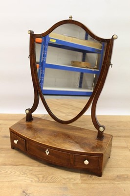 Lot 1467 - George III mahogany bow fronted toilet mirror with shield shape plate above three drawers