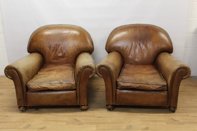 Lot 1414 - Pair of early 20th century brown leather upholstered club chairs