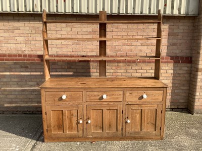 Lot 1081 - Large late Victorian pine two height kitchen dresser with open ledge back above three drawers and four panelled doors to base