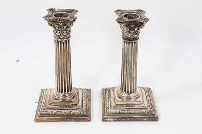 Lot 1966 - Pair of silver Corinthian column candlesticks on square bases