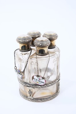 Lot 1964 - Set of four early 20th century French silver and glass toiletry bottles, with gilded decoration, each cap engraved 'Florence'