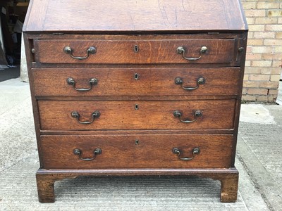 Lot 1034 - Georgian oak bureau with fitted interior and four long graduated drawers below, 90cm wide, 47cm deep, 105cm high