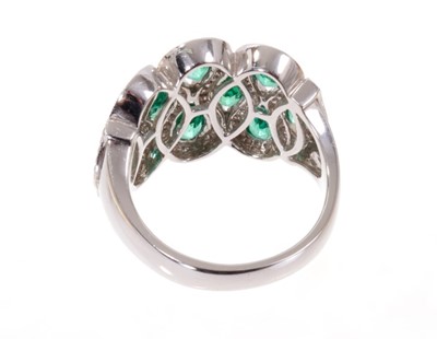 Lot 1969 - Emerald and diamond dress ring with ten oval mixed cut emeralds within brilliant cut diamonds, all in 18ct white gold setting. Finger size approximately O.