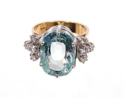Lot 1970 - Aquamarine and diamond cocktail ring with a large oval mixed cut aquamarine measuring approximately 16.4mm x 11.8mm flanked by eight brilliant cut diamonds to the shoulders, all in claw setting on...