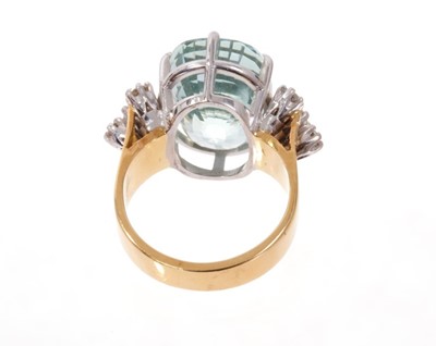 Lot 1970 - Aquamarine and diamond cocktail ring with a large oval mixed cut aquamarine measuring approximately 16.4mm x 11.8mm flanked by eight brilliant cut diamonds to the shoulders, all in claw setting on...