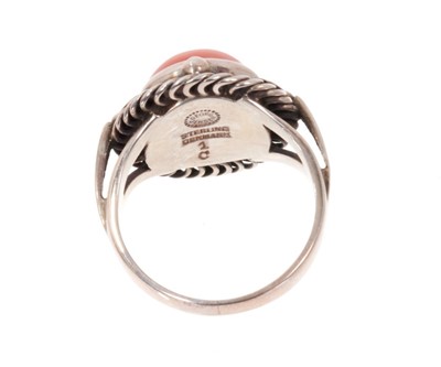 Lot 1977 - Georg Jensen silver and coral ‘moonlight blossom’ dress ring with a round coral cabochon in silver setting with scrolls and foliage, model 1 C, signed. Finger size approximately O1/2-P.