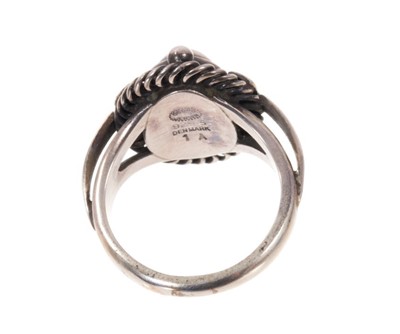 Lot 1978 - Georg Jensen silver ‘moonlight blossom’ dress ring with an cabochon silver centre in silver setting with scrolls and foliage, model 1 A, signed. Finger size approximately M.