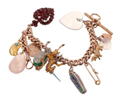 Lot 1990 - Gold charm bracelet with a rose gold curb link bracelet suspending a collection of antique and vintage gold, silver and novelty charms. Length approximately 20cm.