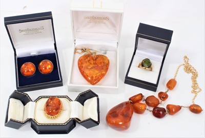Lot 1991 - Group of amber jewellery to include a gold and amber necklace with free form amber beads, an amber heart shaped pendant on chain, a large amber ring in 14ct gold mount, one other dress ring and a p...