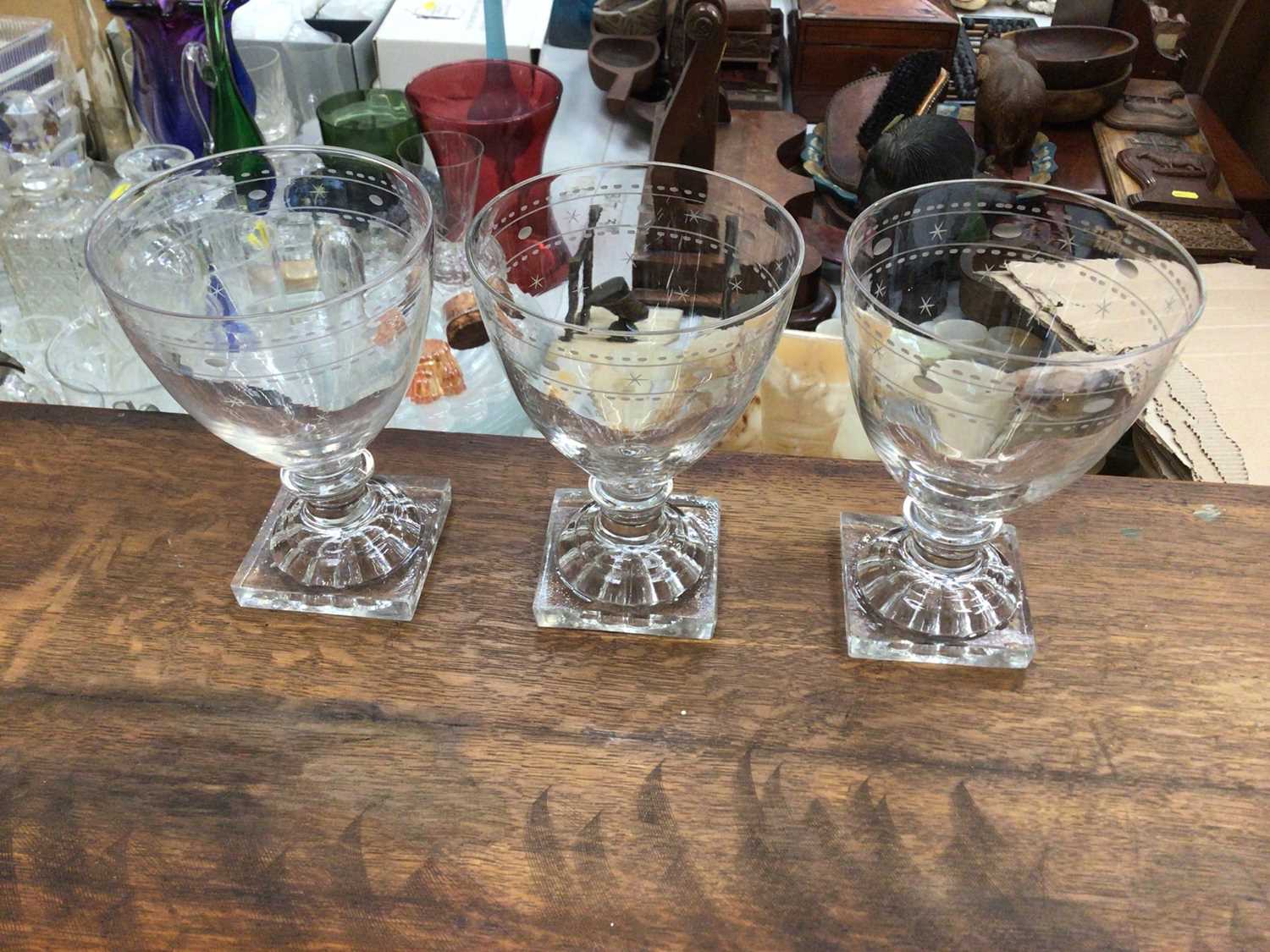 Lot 198 - Three 19th century glass rummers, with lemon squeezer bases, etched with a star and circle pattern