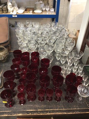 Lot 203 - Quantity of drinking glasses etched with a bamboo pattern, together with a quantity of cranberry drinking glasses