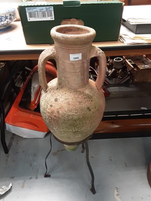 Lot 1060 - Terracotta garden two handled urn in wrought iron stand, 85cm high