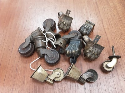 Lot 9 - Collection of furniture fittings including brass castors, table clips, winding handles, and some clock pendulums