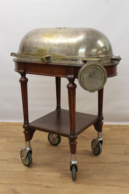 Lot 1478 - Impressive early 20th century mahogany serving trolley, with silver plated domed cylinder cover and folding dish stand, raised on fluted legs with tier below on substantial castors, 98cm wide