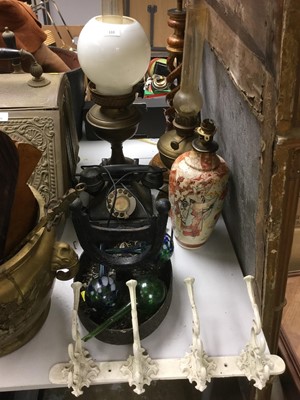 Lot 333 - Antique cast iron boot scraper, Bakelite telephone, white painted coat hooks, oil lamps and sundries