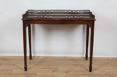 Lot 1485 - George III style mahogany silver table, of serpentine outline with pierced gallery on square tapered legs and spade feet, 82cm wide x 46cm deep x 72cm high