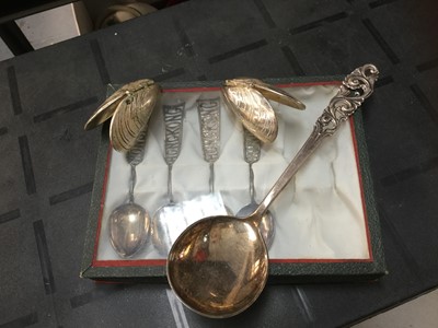 Lot 715 - Pair of silver plated mussel shells, four white metal teaspoons and a silver (830) serving spoon