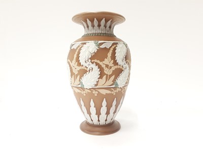 Lot 1304 - Single terracotta colour single vase decorated with white foliage