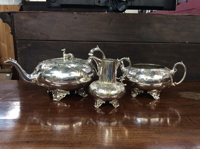 Lot 655 - Victorian three-piece silver plated tea service, the teapot with greyhound finial, each piece with chased pattern and scrollwork feet