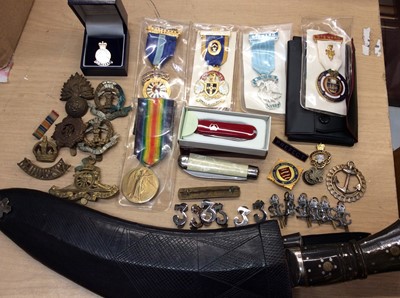 Lot 232 - Group military badges and pins, medals, two penknives and a Kukri